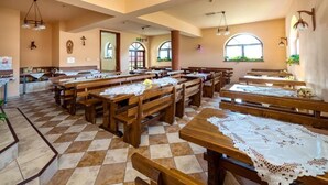 A church interior with wooden pews, a checkered floor, and arched windows. - Dom Wczasowy Na Kamiencu (Białka Tatrzańska)