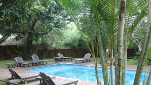 A swimming pool with lounge chairs and a wooden deck. - Kosi Bay Mouth Utshwayelo Lodge and Camp (Mahlungulu)