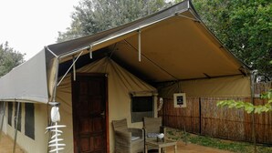 A tent with a door, a small table, a chair, and a sign. - Kosi Bay Mouth Utshwayelo Lodge and Camp (Mahlungulu)