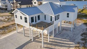 A coastal house with a balcony, a deck, and a view of the water. - Salt Water Heals Everything (Gulf Shores)