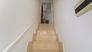 Eine Treppe mit Handlauf, die zu einer Zwischenebene führt.