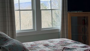 A bedroom with a bed, a TV on a wooden cabinet, and a window with curtains. - Lovely 5-bedroom house in Londonderry perfect for your getaway (Londonderry)