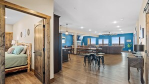 A spacious living area with a dining table, sofa, and kitchen area.