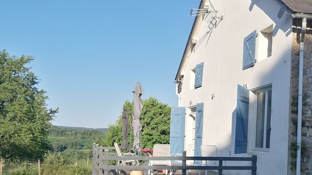 A white building with blue shutters, a wooden deck, and a stone wall. - Enter the wonderful world of nature and the stars of Morvan (Arleuf)