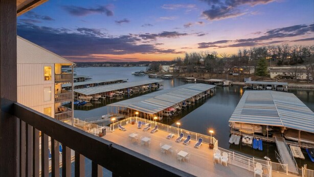 A waterfront hotel with a pool area, docked boats, and a view of the marina. - Lakeview for Two - Lakeside Pool & Top Floor! (Osage Beach)
