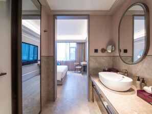 A modern hotel room with a large bed, a television, a bathroom with a large mirror, and a view of the hotel lobby. - Mercure Lanzhou University Tianshui (Lanzhou)