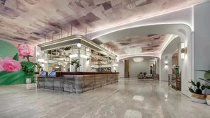 A hotel lobby with a reception desk, seating area, and a decorative ceiling. - Mercure Lanzhou University Tianshui (Lanzhou)