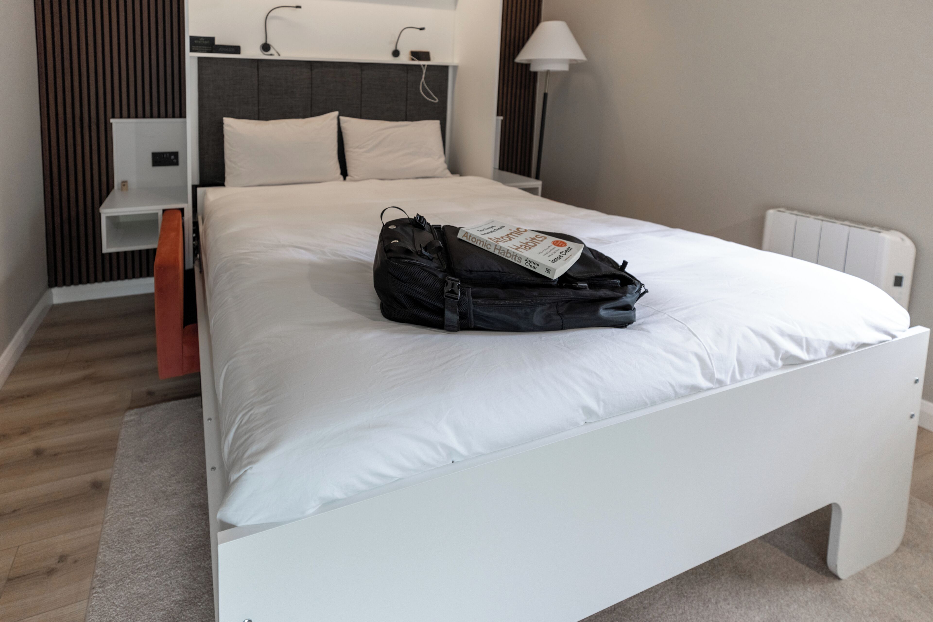 Bright modern bedroom with king bed and built-in reading lights