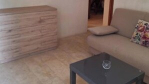 A living room with a sofa, a coffee table, and a wooden cabinet. - Apartment 'Residenze Uliveto - Residenza 10' Private Terrace and Air Conditioning (Nardò)