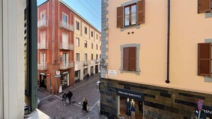 Une vue de rue avec des bâtiments, une enseigne indiquant « RINASCIMENTO » et une autre indiquant « VIA MASCARI ».