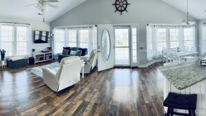 A spacious kitchen with white cabinets, a granite countertop, and a large island. - Surf City Ocean View - 4-min Walk to Beach - Walk to Restaurants/Bars (Surf City)
