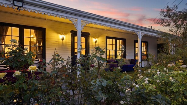 A white building with a porch, large windows, and a sunset sky. - Luxury Glam Pool Retreat Near Glenelg Beach-sleeps 10 (Dover Gardens)