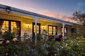 A white building with a porch, large windows, and a sunset sky. - Luxury Glam Pool Retreat Near Glenelg Beach-sleeps 10 (Dover Gardens)