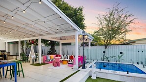 An outdoor patio with a pool, seating area, and string lights. - Luxury Glam Pool Retreat Near Glenelg Beach-sleeps 10 (Dover Gardens)