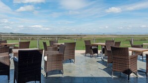 An outdoor patio with wicker furniture and a view of the countryside. - Host Stay 11 Troutbeck (Penrith)