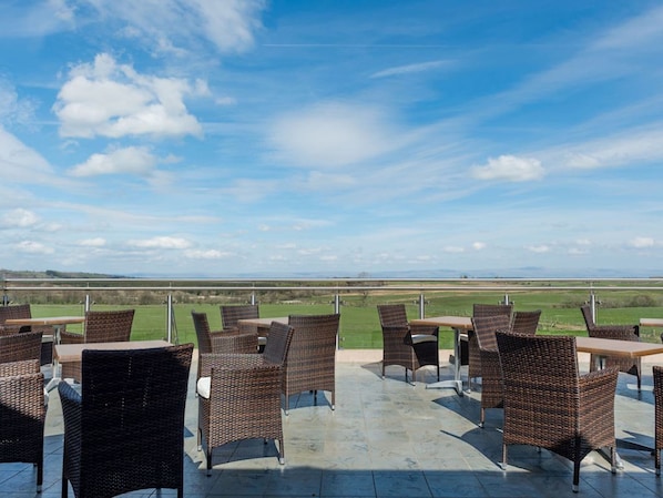 An outdoor patio with wicker furniture and a view of the countryside. - Host Stay 11 Troutbeck (Penrith)