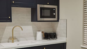 A kitchen with a microwave, toaster, and sink. - Host Stay Studio Temperance House (Saltburn-by-the-Sea)