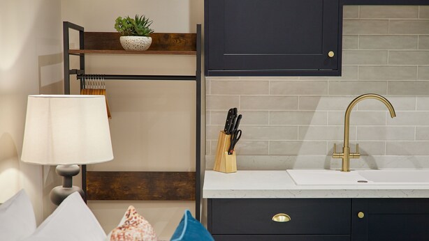 A modern kitchen with a white countertop, a gold faucet, and a knife block. - Host Stay Studio Temperance House (Saltburn-by-the-Sea)