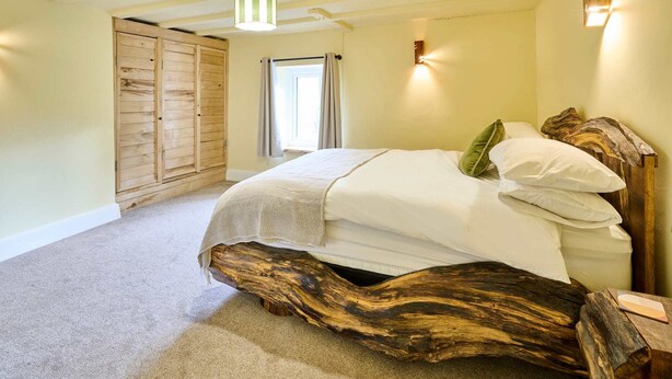 A bedroom with a large bed, wooden wardrobe, and a window with curtains. - Host Stay Morley House (Barnstaple)