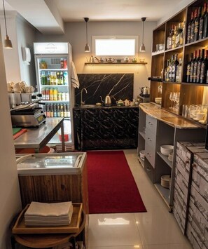 A modern kitchen with a marble countertop, a coffee machine, a wine rack, and a red carpet. - las vegas (Batumi)