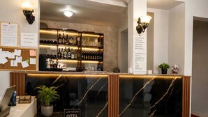 A hotel reception area with a marble counter, a sign reading 'Las Vegas Hotel,' and a wall-mounted menu board. - las vegas (Batumi)