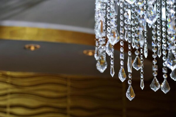 A chandelier with multiple crystal elements.