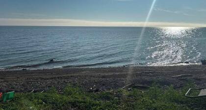 Cozy 2 bedroom Solar Powered Cedar Cottage on the Bay of Chaleur at Charlo NB.