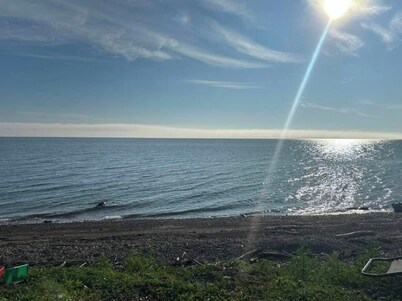 Cozy 2 bedroom Solar Powered Cedar Cottage on the Bay of Chaleur at Charlo NB.