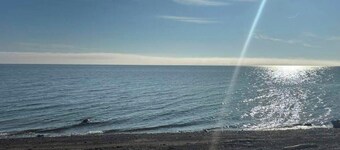 Cozy 2 bedroom Solar Powered Cedar Cottage on the Bay of Chaleur at Charlo NB.