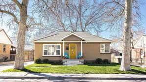 A single-story house with a front porch, a front door, and a small front yard. - 3-Bedroom house in tree-lined neighborhood in Millcreek (Salt Lake City)