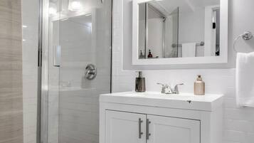 Shower, hair dryer, towels, shampoo