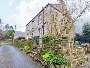 A stone building with a stone staircase leading to the entrance, surrounded by greenery. - Langcliffe House (Skipton)