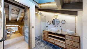 A modern bathroom with a wooden vanity, two sinks, and a large mirror. - Chalou LUXE & COSY chalet 8 personnes (Hérémence)