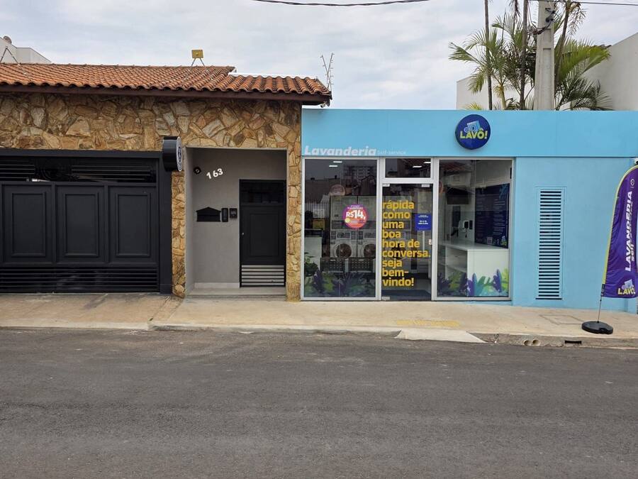 A building with a stone facade and a blue storefront.