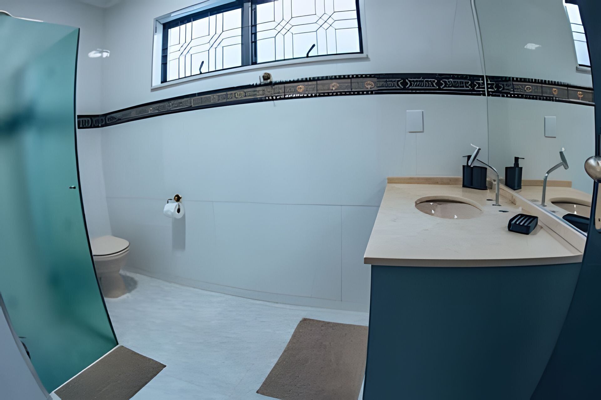 A modern bathroom with a toilet, sink, and shower.