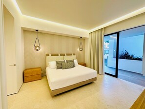 A modern bedroom with a large bed, bedside tables, and a view to the outside. - Romantic Retreat Soho PV (Puerto Vallarta)