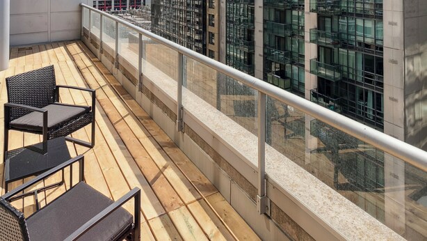 A rooftop terrace with outdoor seating, a glass balustrade, and views of surrounding high-rise buildings including a distinctive tower. - Luxury DT Escape 3Bed2Bath! Pool |Gym |Parking (Toronto)
