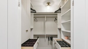 A walk-in closet with open shelves, hanging space, and a wooden floor. - Luxury DT Escape 3Bed2Bath! Pool |Gym |Parking (Toronto)