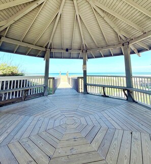 A wooden deck leading to a beach with a covered pavilion. - Steps to Beach • 2 Pools, Pet-Friendly, Playground (Port St. Joe)