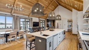 A spacious kitchen with a large island, wooden ceiling, and modern pendant lights. - Four bedroom  in United States of America, Winchester (Winchester)