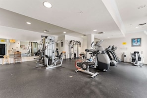 A gym with various exercise equipment, including treadmills and weight machines.