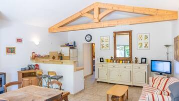 A compact living space with a kitchen, dining area, and a sofa.