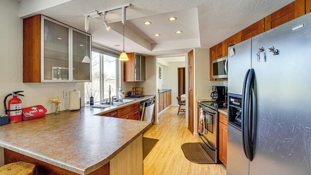 A modern kitchen with a large island, stainless steel appliances, wooden cabinets, and a pendant light. - 18-Acre Working Farm w/ Mtn Views! Dolores Escape (Dolores)