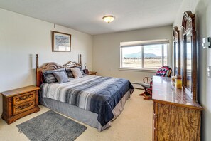 A bedroom with a bed, bedside tables, a dresser, a window, and a framed picture on the wall. - 18-Acre Working Farm w/ Mtn Views! Dolores Escape (Dolores)