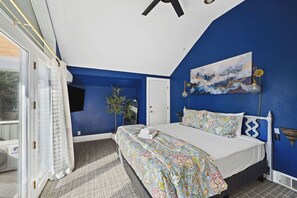 A bedroom with a bed, a painting, a mirror, and a window with curtains. - Walk to Beach Coeur d'Alene Retreat w/ Lake Views & BBQ Area (Coeur d'Alene)