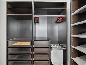A metal-framed storage unit with multiple shelves and drawers, a metal sink, and a towel rack. - Luxe 3 bd | Boston | Penthouse (Boston)