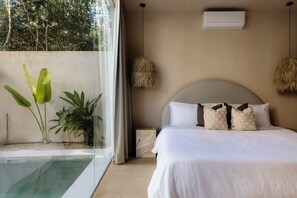 A bedroom with a bed, a window with curtains, a hanging light fixture, and a small bedside table. - Villa Ka'an Pura Selva luxury and nature near the beach (Tulum)