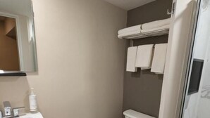 A bathroom with a sink, toilet, and a glass shower enclosure. - Star Inn & Suites (Chicago Heights)