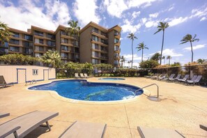 A hotel with a pool, lounge chairs, and palm trees. - 🌅 Maui Magic! Panoramic Beachfront Stay! Ocean Views, Pool, Hot Tub, Sleeps 8🌊 (Kihei)