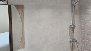 Un baño moderno con inodoro, lavabo y ducha.